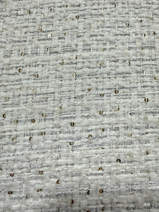 Primer plano del lurex plata y las lentejuelas sobre el tweed blanco