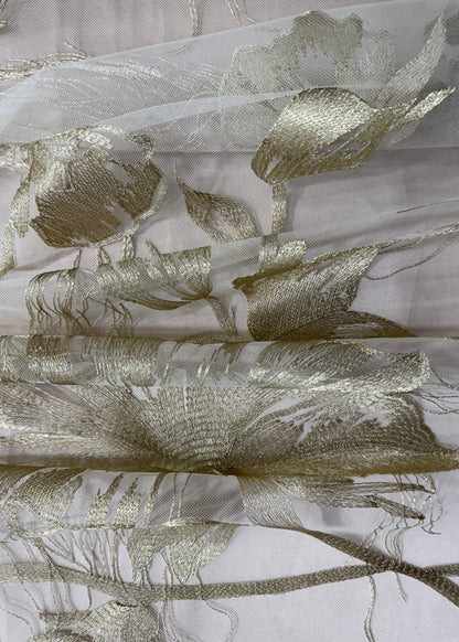 Tela transparente con flores bordadas en hilo dorado